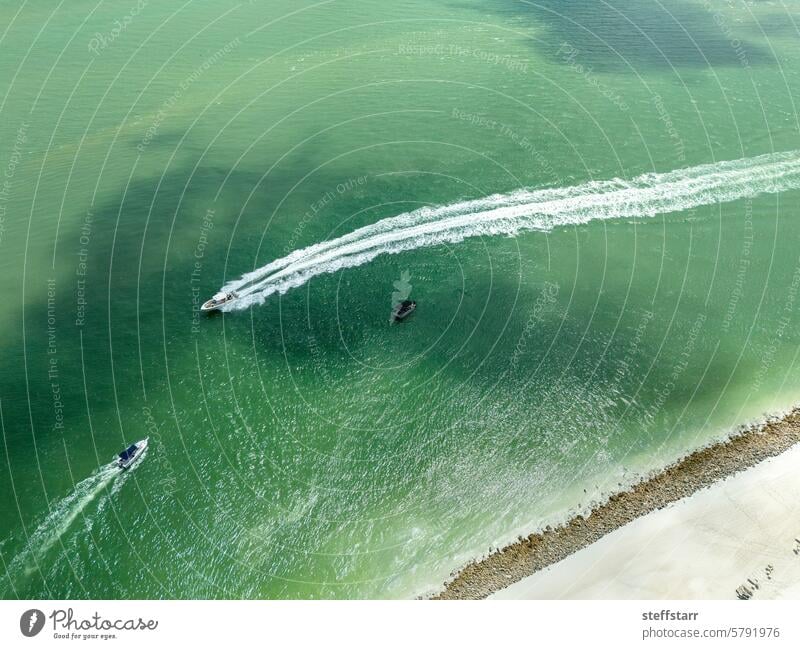 View from above of boats moving through the water in the Gulf of Mexico Sailing Aquatics Ocean coast coastal strip Florida go boating Emerald green sea