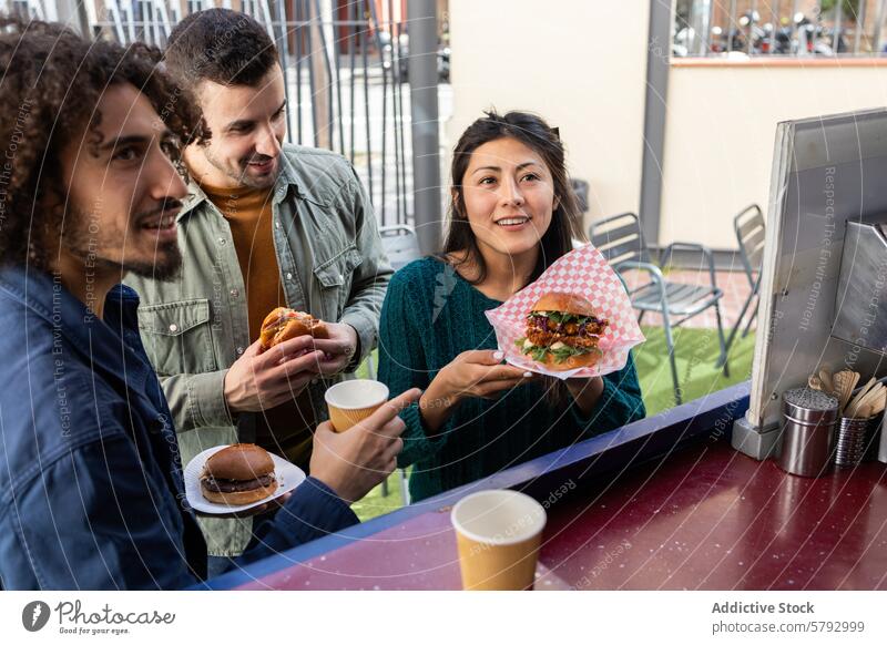 Group of friends enjoying food at a food truck street food eating gourmet urban lifestyle sharing moment diverse group woman burger to-go coffee cup paper plate