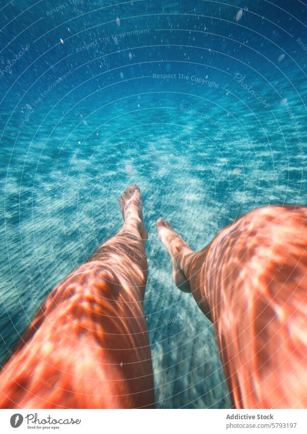 Underwater perspective of legs floating in clear Sardinian sea underwater sardinia italy sunlight filter crystal-clear summer vacation swimming serene tranquil