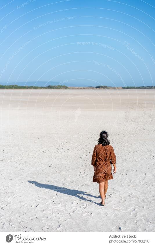 Woman walking alone on a serene Venta Porcus Saltwater Lake woman solitude sardinia sky clear italy travel leisure tranquil sea coast coastline sardinian