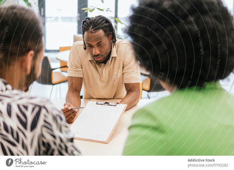 Focused Discussion at a Business Meeting multiethnic black woman afro hair african american meeting business professional discussion colleague office modern