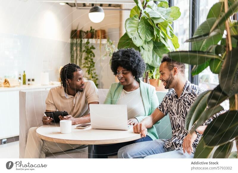 Diverse team collaborating in a modern coworking space collaboration professional young discussion laptop tablet indoor greenery workplace meeting brainstorming