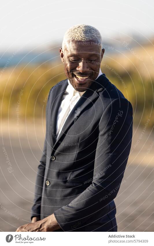 Elegant African American man posing on the beach african american style fashion suit smile elegance model male black outdoor sandy dapper charming handsome