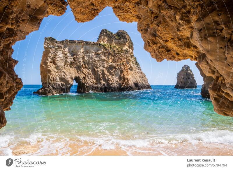 Small, heavenly beach photographed from cave, near Portimão, Algarve, Portugal algarve atlantic cliff coast holiday idyllic landscape nature ocean paradise