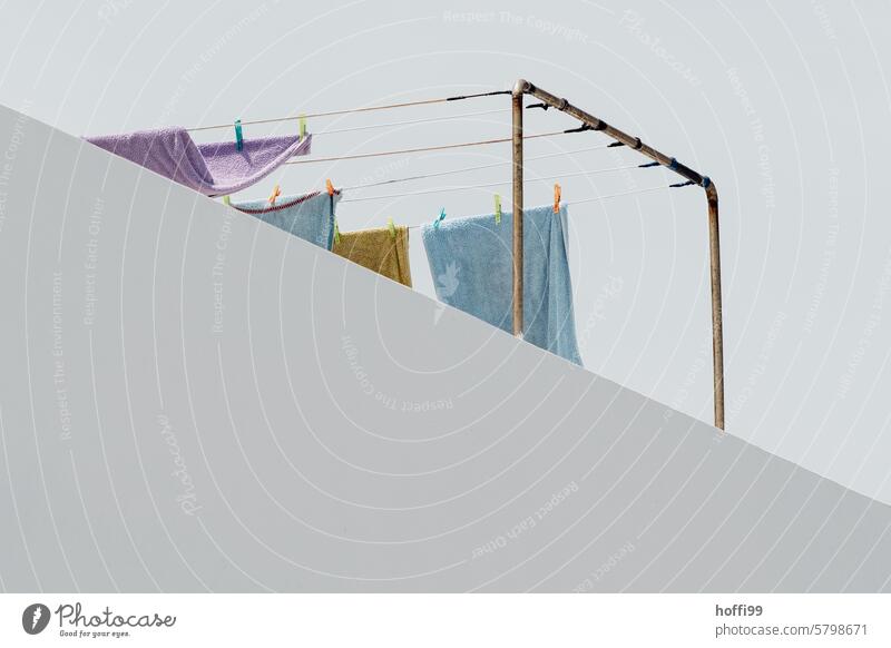 Laundry on a half-covered washing line on a balcony clothesline Washing day Hang Dry Fresh Hang up Clean Photos of everyday life Towels Housekeeping Balcony
