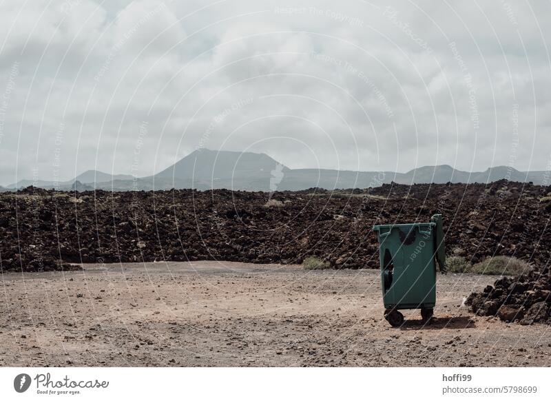 Garbage bin in front of a cooled lava field with volcanic cones in the background Trash container Waste management Lava field Volcano Nature Landscape