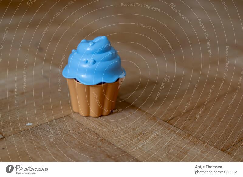 Blue toy or toy cake on parquet flooring Toys Sand toys Ice Cupcake Infancy Playing Sandpit Child Children's game