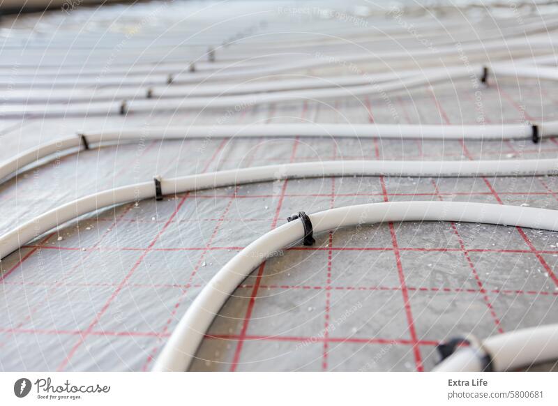 Pipe system of floor heating mounted in residential building under construction Across Adjust Adjustable Assembled Bend Civil Engineering Climate Complex