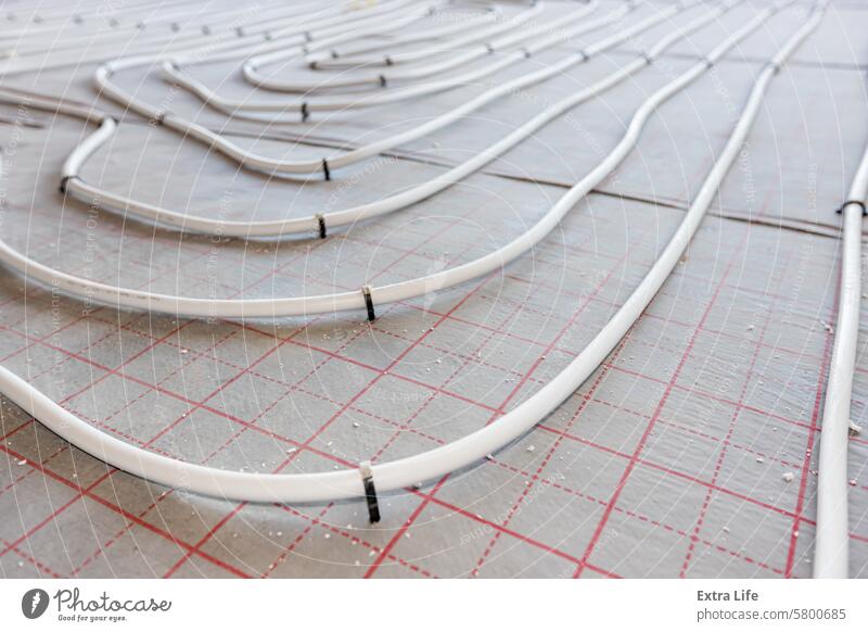 Pipe system of floor heating mounted in residential building under construction Across Adjust Adjustable Assembled Bend Civil Engineering Climate Complex