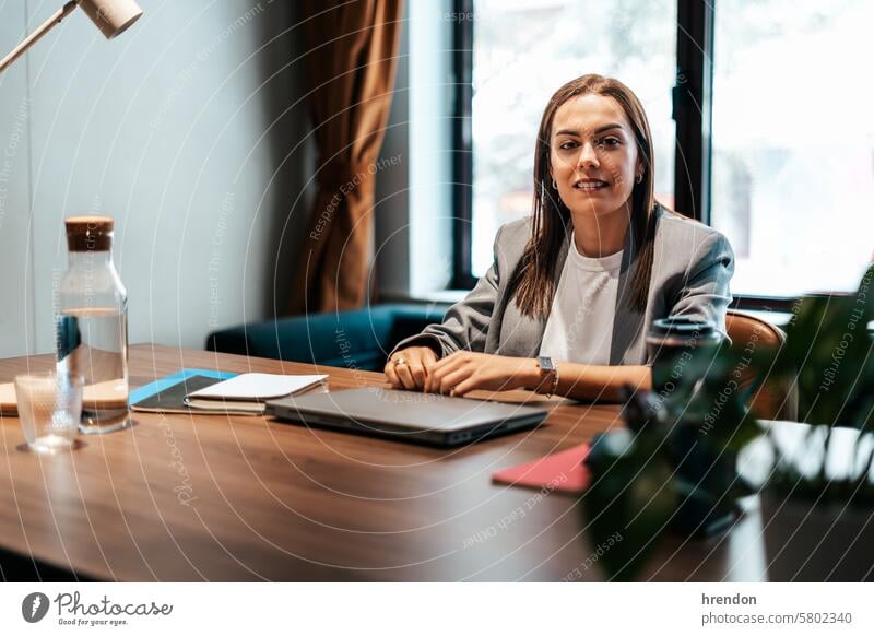 portrait of a businesswoman in the office lead leader working laptop company satisfied indoor entrepreneur professional manager success desk proud
