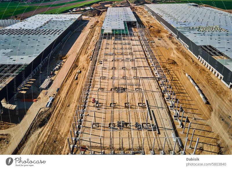 Construction site with steel frame structure of warehouse building, aerial view storage construction logistic storehouse roof infrastructure assembly