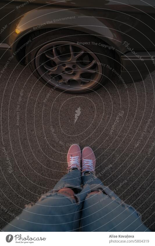 pink shoes and black car wheels legs ripped jeans blue jeans car rim Transport Wheel rim Tire Colour photo
