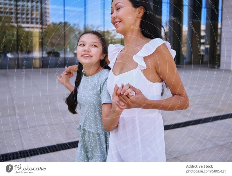 Girl with autism spectrum having fun with her mother while walking in the city Woman female daughter child person with autism ADHD neurodiversity childhood kid