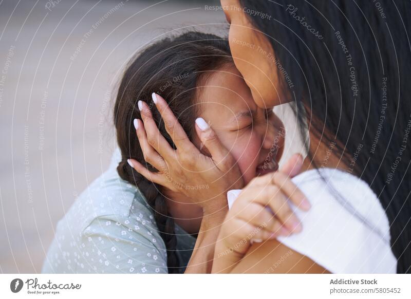 Embrace Between Mother and Daughter with autism spectrum embrace mother daughter love comfort close-up tender affection family child woman caring hug emotion