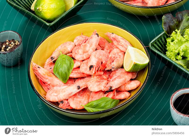 Raw shrimps prawns, fresh prawns seafood. green omega lime appetizer big prawns preparation seafood cuisine uncooked natural citrus table pile delicious