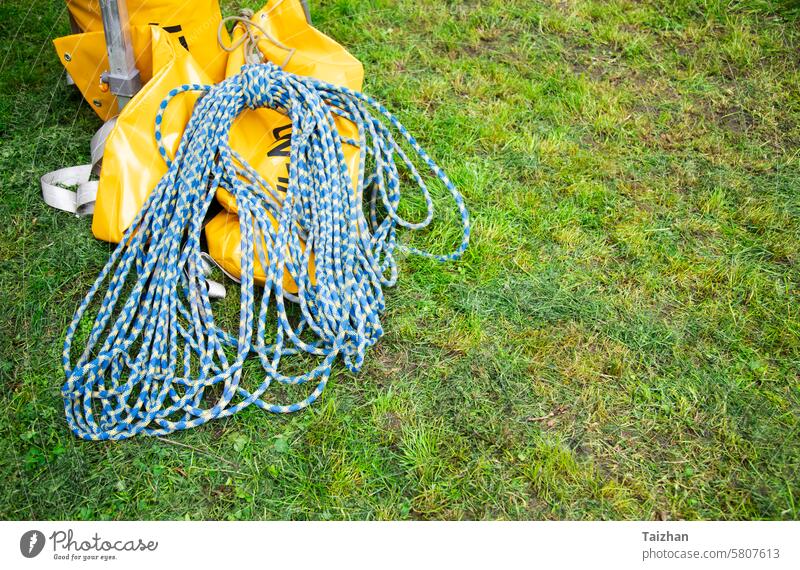 Blue climbing rope on green grass .  Background image of the rope for active sports. Copy space abstract activity adult adventure blue braid cable climber
