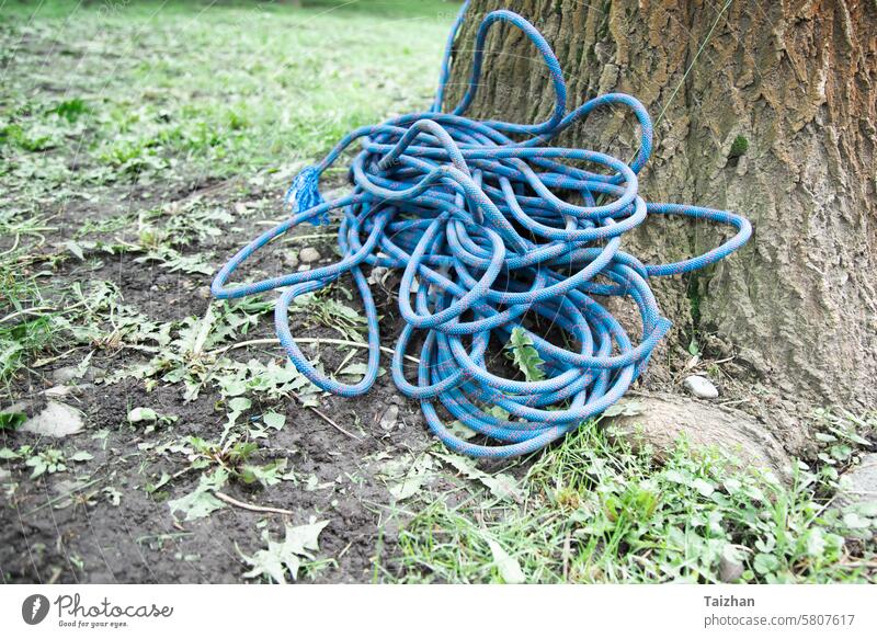 climbing equipment on the ground. climbing Rope rolled up , copy space abstract activity adventure background blue carabine carabiner climber closeup concept