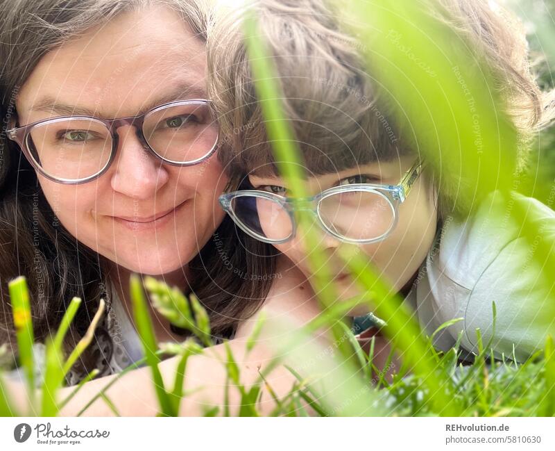 Mother lying in the meadow with her son Woman Child Son Together Family & Relations relation Love Infancy portrait Day naturally Joy Smiling Human being