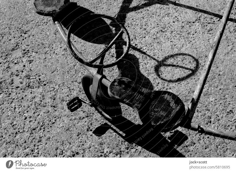 Strange scooter casts shadows on concrete floor Toys Scooter Exceptional Uniqueness Detail Structures and shapes Silhouette Concrete slab Style differently