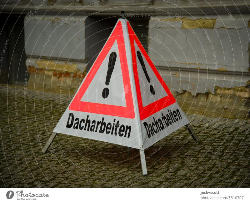 Attention roof work roofing display Signs and labeling Caution Warning sign Safety Characters German esteem Sidewalk Cobblestones peril Exclamation mark