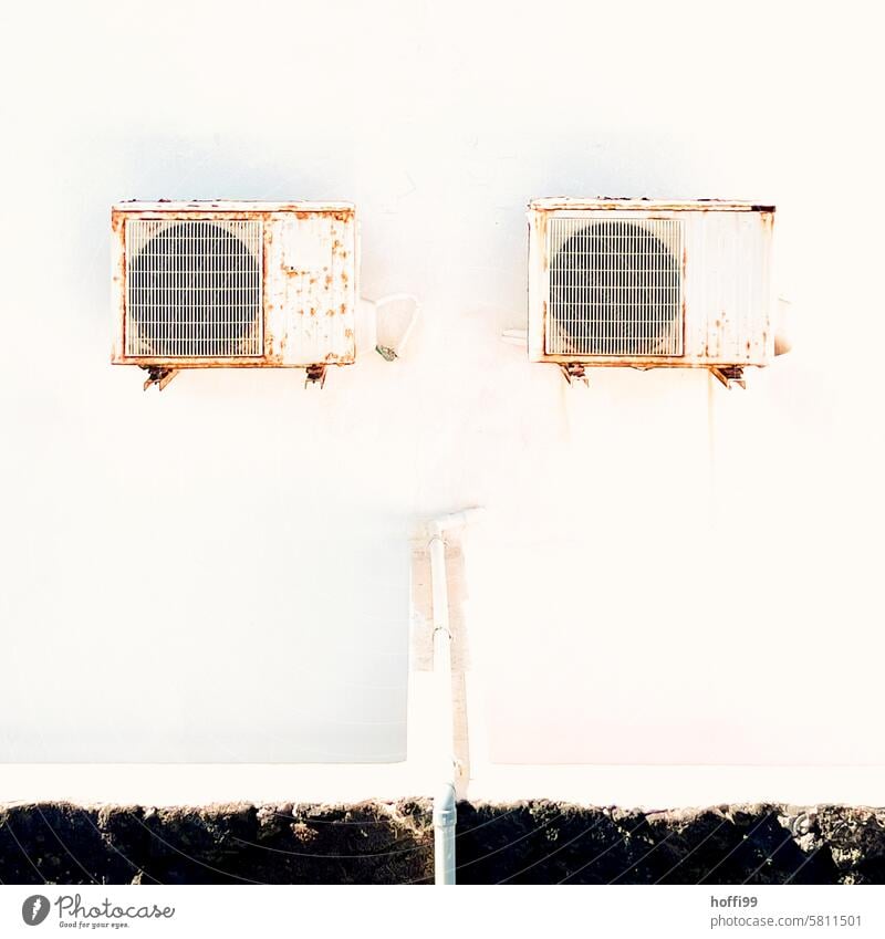 Rusty air conditioning units on white exterior wall Air conditioning Concrete Gloomy Cooling Climate change Facade air conditioner Technology Cold Minimalistic