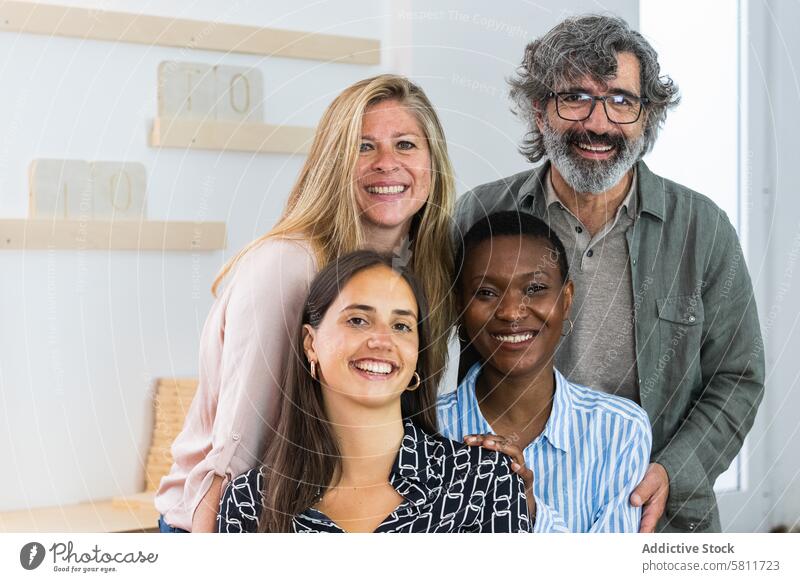 Cheerful diverse coworking women looking at camera colleague workplace portrait coworker cheerful workspace together smile company female multiethnic
