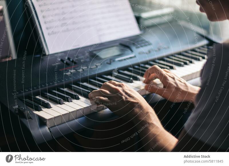 man playing piano with a music sheet instrument musician pianist black melody classic sound performance concert classical jazz entertainment person artist male