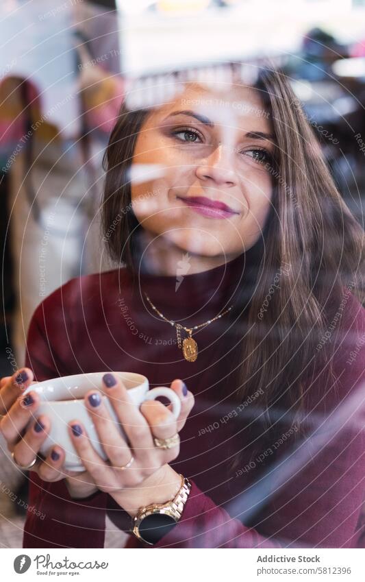 Smiling woman with cup of coffee in cafe dream window smile pensive happy drink charming dreamy female adult beverage relax free time lifestyle rest enjoy
