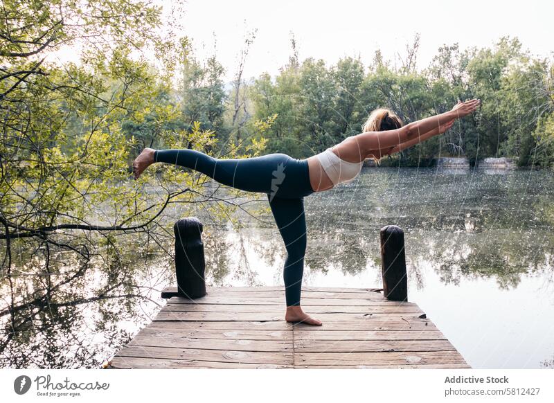 woman in sportswear doing yoga in nature near a lake healthy exercise lifestyle fitness body workout caucasian training pilates young wellness activity active