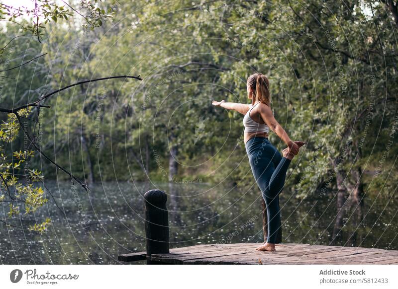 woman in sportswear doing yoga outdoors near a lake healthy exercise lifestyle fitness body workout caucasian training pilates young wellness activity active