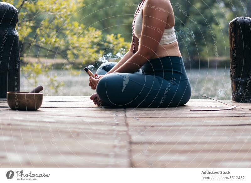 Young woman meditating and doing yoga in nature meditation healthy relaxation body adult pose lifestyle balance exercise young person concentration zen peaceful