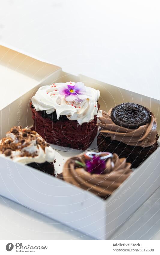 Assorted vegan desserts in paper box on table cake pastry sponge cream whipped bakery food tasty baked meal appetizing yummy gourmet sweet various fresh