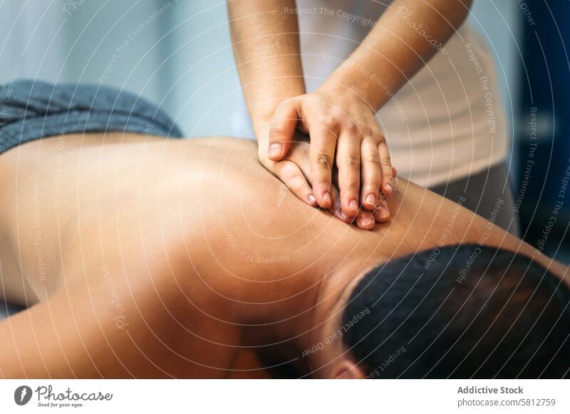 young woman treating a male patient back. massage physiotherapy. close-up therapist health treatment rehabilitation female physiotherapist care masseur medicine