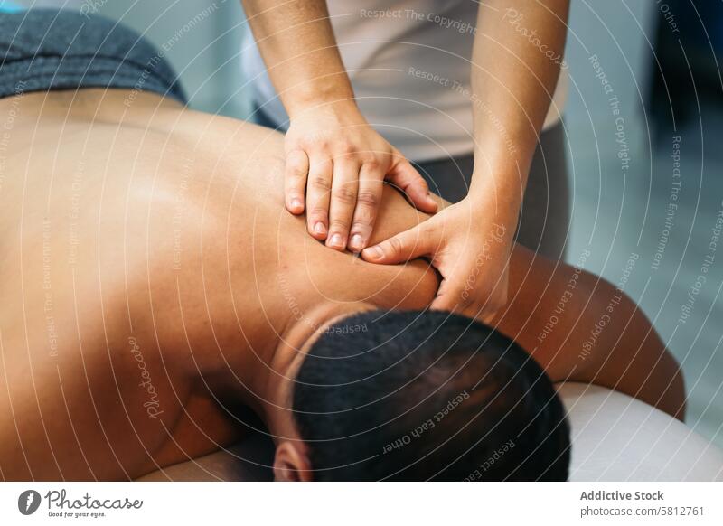 young woman treating a male patient. back massage physiotherapy. close-up therapist health treatment rehabilitation female physiotherapist care masseur medicine