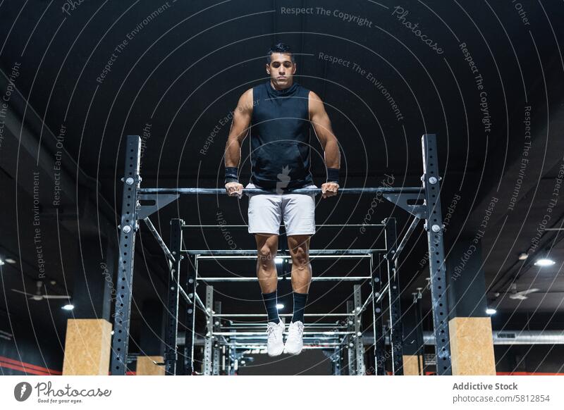 Hispanic sportsman exercising on crossbar training gym exercise workout healthy lifestyle practice challenge sporty activewear sportswear wellness hobby