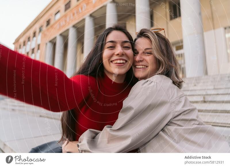Selfie of two student girls smiling sitting on the stairs caucasian female people portrait happy lifestyle attractive beauty smile cheerful woman beautiful