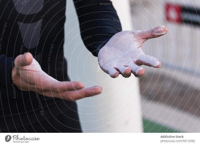 Athletic man with powdered hands sportsman chalk training prepare talcum athlete exercise gymnast workout male lifestyle activity asian ethnic demonstrate show