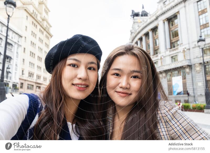 Selfie of asian female friends in the city people street young happy lifestyle fun outdoors urban cheerful fashion smiling casual modern youth enjoying