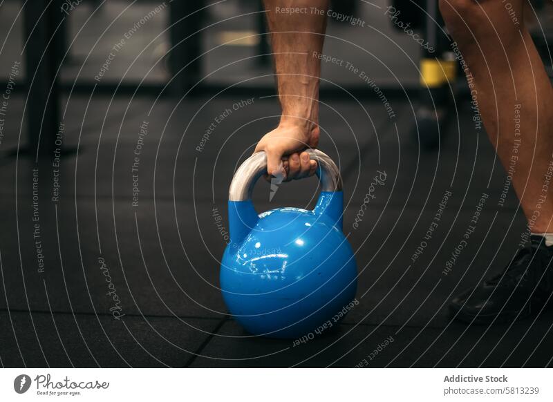 hand of a man taking a kettlebell training workout gym sport exercise fitness athlete power strong young bodybuilding muscular equipment strength weight healthy