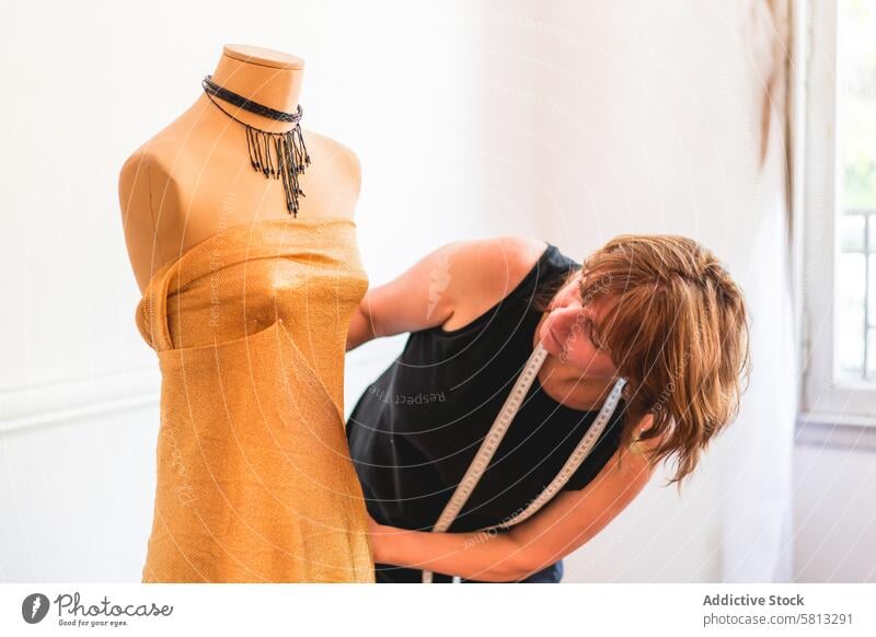 Fashion designer dressing a mannequin with garment 50s Business Person adult businesswoman clothing confidence confident creativity dressmaker empowerment