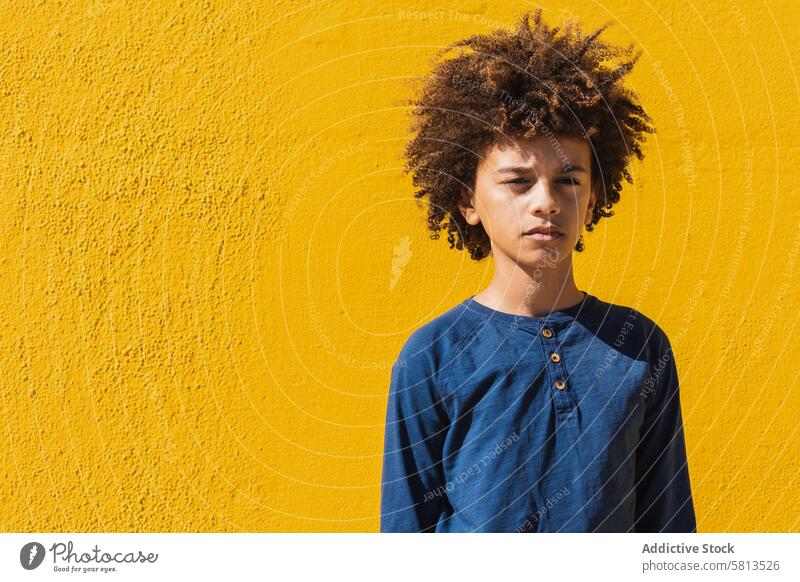 Pensive ethnic boy with Afro hairstyle kid afro curly hair pensive thoughtful teenage think portrait colorful male child ponder youngster serious