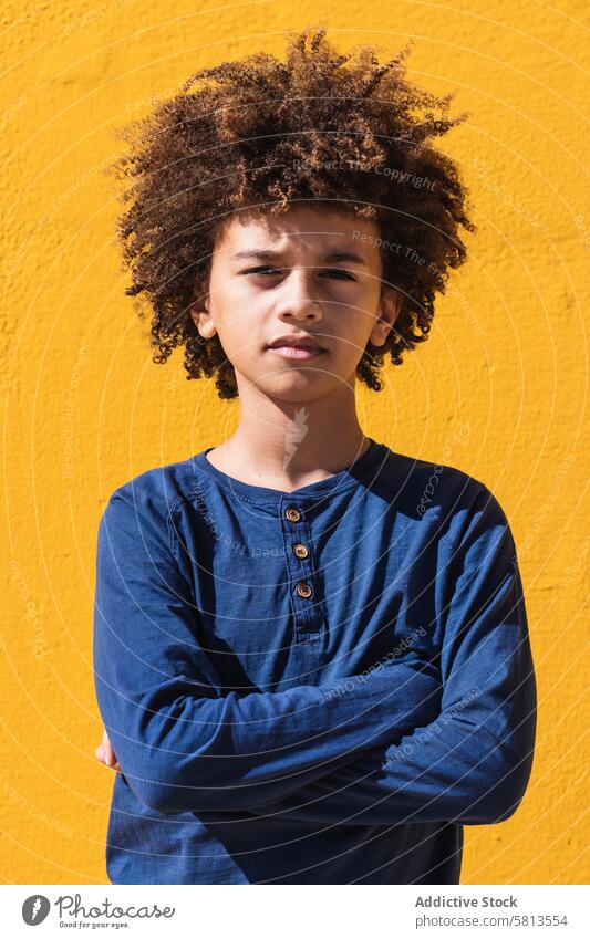 Pensive ethnic boy with Afro hairstyle kid afro curly hair pensive thoughtful teenage think portrait colorful male child ponder youngster serious