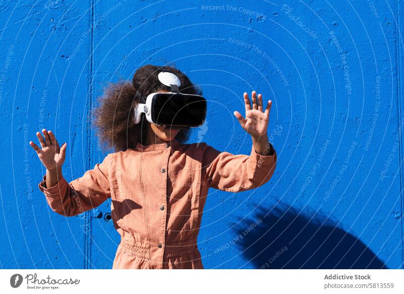 Ethnic teenager in VR headset exploring cyberspace kid vr virtual reality explore girl device using goggles female african american afro black ethnic trendy