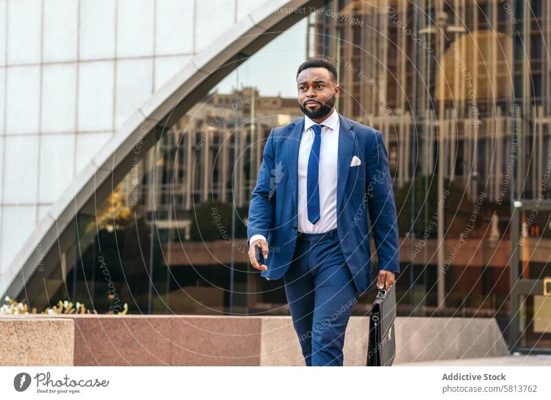 Business black man in suit leaving the office holding his work briefcase business professional executive success entrepreneur finance businessman corporate