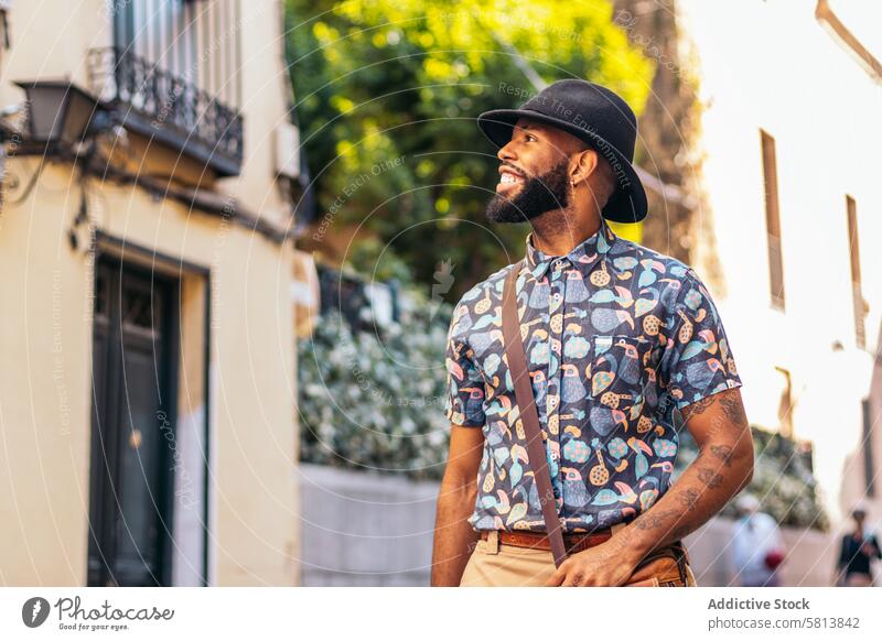 Stylish black man walking on the city street lifestyle young urban male person stylish guy outside people casual outdoors adult fashion summer handsome