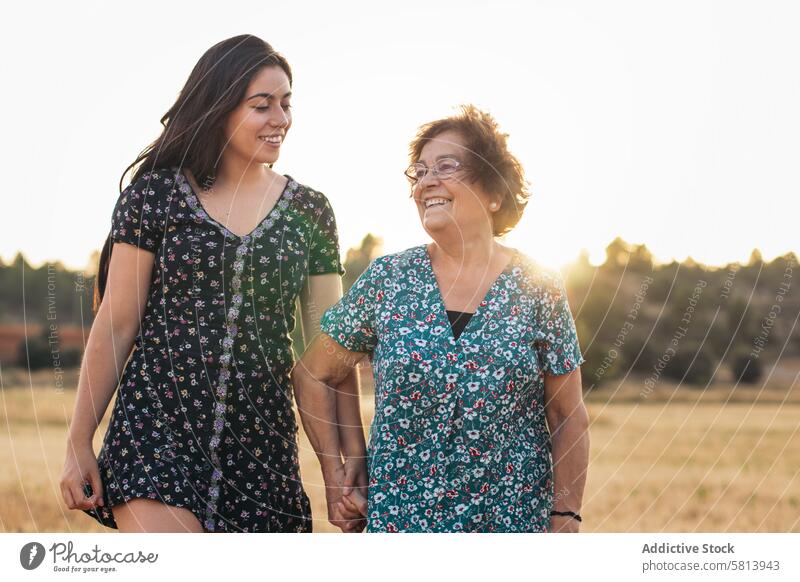 Taking advantage of life Grandmother and granddaughter in a field of sunflowers. woman elderly nature people summer agriculture outdoor yellow senior happy