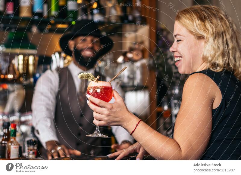 stylish black bartender offering a customer a cocktail barman beverage mixologist nightclub alcohol barkeeper glass drink work professional bartending indoors