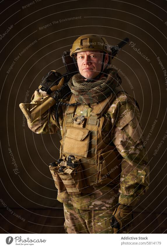 portrait of an airsoft soldier with camouflage clothing and a rifle with a telescopic sight military army armed war man weapon force gun special helmet infantry