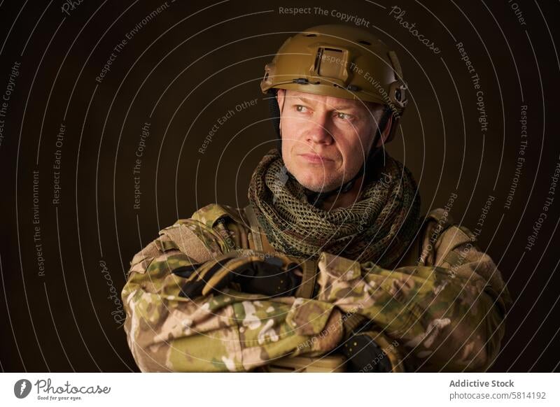 portrait of a soldier in airsoft camouflage clothing leaning on his rifle military army war special armed weapon gun helmet uniform warrior men force male black