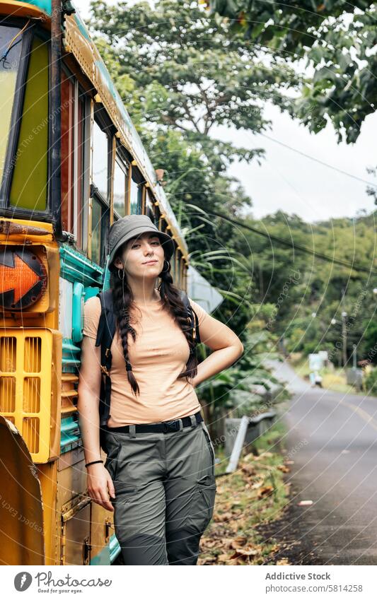 Woman leaning on a vintage school bus abandoned countryside old rural nature transportation landscape travel vehicle outdoor broken rusty forgotten grass